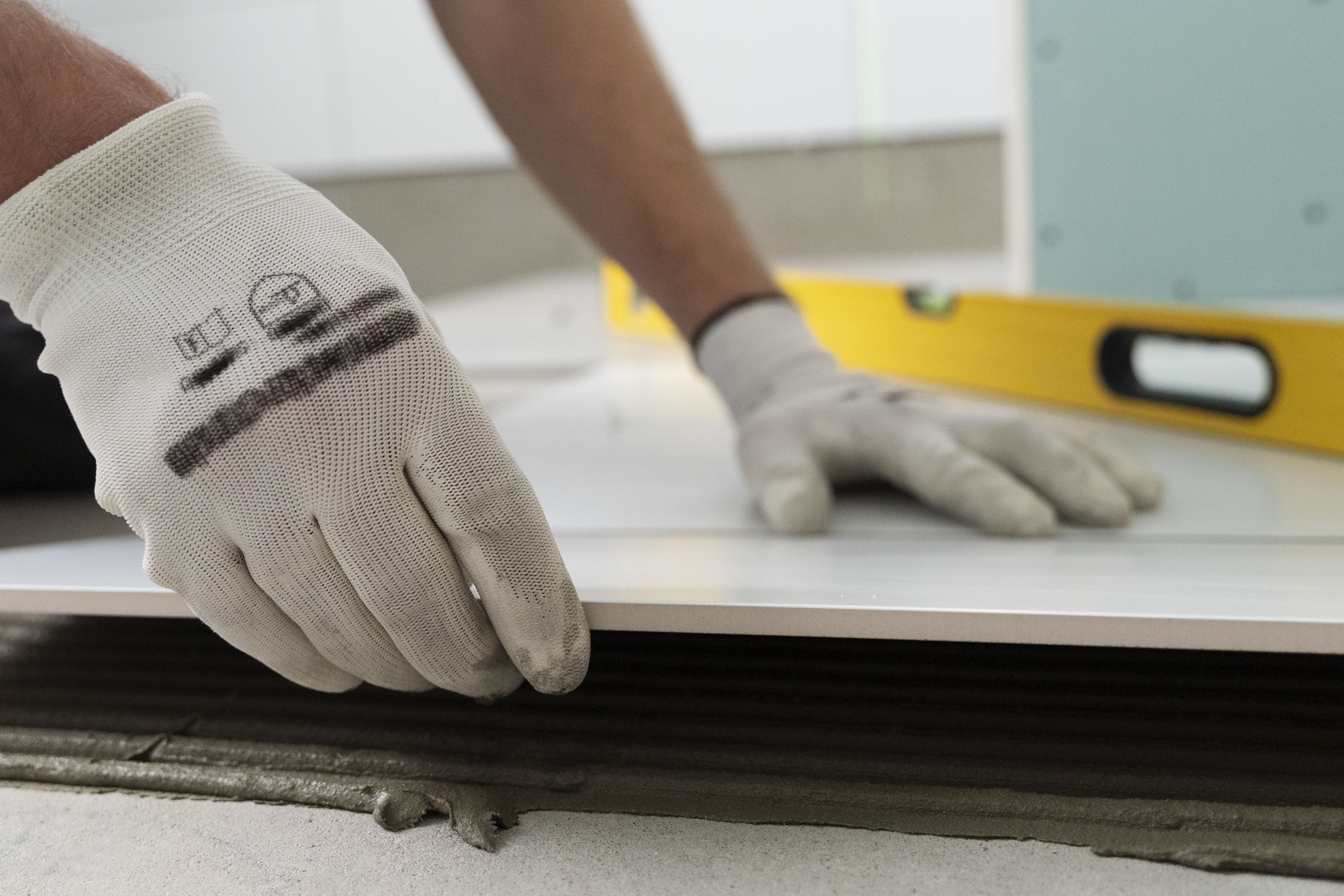 tiler-working-on-renovation-of-apartment